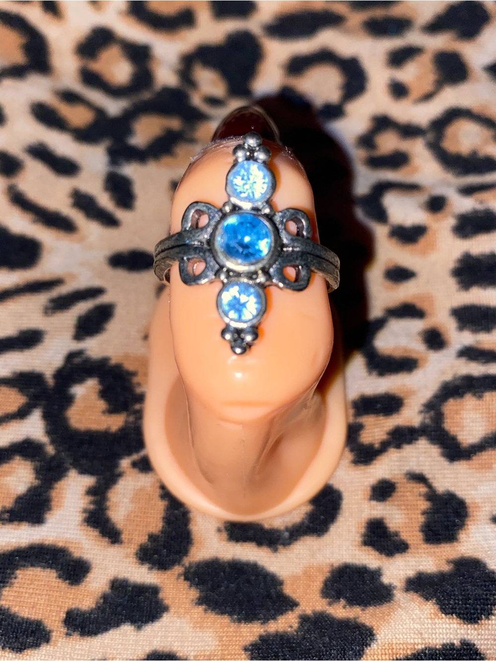 Silver ring with blue gemstones and ornate detailing